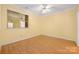 Bright bedroom featuring wood look floors, a ceiling fan and neutral paint at 3951 Jasmine Ln, Denver, NC 28037