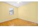 Bedroom with hardwood floors, a window for natural light, and a ceiling fan at 3951 Jasmine Ln, Denver, NC 28037