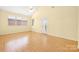 Light filled bedroom has vaulted ceiling, wood look floors and multiple windows at 3951 Jasmine Ln, Denver, NC 28037