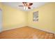 Cozy bedroom with hardwood floors, ceiling fan, and great natural light through a large window at 3951 Jasmine Ln, Denver, NC 28037