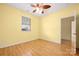 Bedroom with hardwood floors, open doorway, ceiling fan, and natural light from the window at 3951 Jasmine Ln, Denver, NC 28037