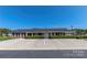 Well-maintained brick building featuring a covered entrance, ample parking, and neat landscaping at 3951 Jasmine Ln, Denver, NC 28037