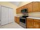 Bright kitchen with wooden cabinets and stainless steel appliances at 3951 Jasmine Ln, Denver, NC 28037