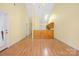 Open-concept living area with hardwood floors and a kitchen featuring wooden cabinets at 3951 Jasmine Ln, Denver, NC 28037
