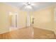 Bedroom with multiple entrances, neutral paint, wood look floors and a ceiling fan at 3951 Jasmine Ln, Denver, NC 28037