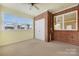 Bright sunroom features brick accent wall, neutral carpet, ceiling fan and lots of natural light at 3951 Jasmine Ln, Denver, NC 28037