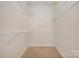 Walk-in closet with wire shelving and neutral carpeting and paint at 3951 Jasmine Ln, Denver, NC 28037