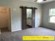 Spacious bedroom features stylish barn door leading to bath and walk-in closet at 408 N Peterson St, Stanley, NC 28164