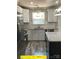 Well-lit kitchen features stainless appliances, granite countertops and stylish gray floors at 408 N Peterson St, Stanley, NC 28164