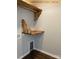 Well-organized laundry area with custom wood shelving and convenient pet door access at 408 N Peterson St, Stanley, NC 28164