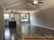 Open-concept living space featuring stylish floors, neutral paint, and a view into the kitchen area at 408 N Peterson St, Stanley, NC 28164