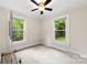 Well-lit bedroom with two windows, a ceiling fan, and neutral carpet at 430 Sells Rd, Salisbury, NC 28144