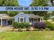 Charming blue home with lush landscaping and a well-manicured front yard, with an open house banner displayed above at 430 Sells Rd, Salisbury, NC 28144