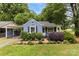 Charming blue home with lush landscaping and a well-manicured front yard with black shutters at 430 Sells Rd, Salisbury, NC 28144