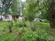 Exterior of a house with a garage surrounded by lush green trees at 455 Running Brook Rd, Midland, NC 28107
