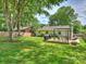 Expansive backyard with a deck, grill, pergola, and ample green space at 4921 Doris Ave, Charlotte, NC 28205