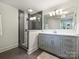 Modern bathroom featuring a glass-enclosed shower, updated fixtures, and neutral color palette at 4921 Doris Ave, Charlotte, NC 28205