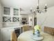Charming dining area featuring a stylish chandelier, wine rack, and wicker chairs at 4921 Doris Ave, Charlotte, NC 28205