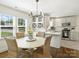 Bright dining area featuring a stylish chandelier, wine rack, and wicker chairs at 4921 Doris Ave, Charlotte, NC 28205