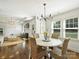 Inviting dining area with chandelier lighting, hardwood floors, and a view into a cozy living room at 4921 Doris Ave, Charlotte, NC 28205