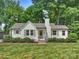 Charming exterior view of a well-manicured home with lush green lawn and landscaping at 4921 Doris Ave, Charlotte, NC 28205