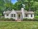 Charming exterior view of a well-manicured home with lush green lawn and landscaping at 4921 Doris Ave, Charlotte, NC 28205