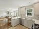 Bright kitchen featuring stainless steel appliances, white countertops, and open layout to living room at 4921 Doris Ave, Charlotte, NC 28205