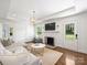 Bright living room with a cozy fireplace, modern lighting, and a comfortable sectional sofa at 4921 Doris Ave, Charlotte, NC 28205