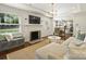 Bright living room with a cozy fireplace, modern lighting, and a comfortable sectional sofa at 4921 Doris Ave, Charlotte, NC 28205