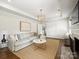 Bright living room with a cozy fireplace, modern lighting, and a comfortable sectional sofa at 4921 Doris Ave, Charlotte, NC 28205