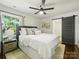 Serene main bedroom with soft lighting, neutral tones, and a sliding barn door to the ensuite bathroom at 4921 Doris Ave, Charlotte, NC 28205