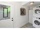 Cozy mud room featuring door with stained glass, washer and dryer, and gray wood flooring at 4921 Doris Ave, Charlotte, NC 28205