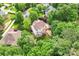Aerial view of a home with a deck, surrounded by lush trees in a well-maintained neighborhood at 5022 Saybrook Dr, Harrisburg, NC 28075