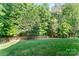 Image showing large well-kept lawn surrounded by a wooden fence and mature trees at 5022 Saybrook Dr, Harrisburg, NC 28075