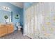 Blue bathroom with single vanity, toilet and shower with ducky shower curtain at 5022 Saybrook Dr, Harrisburg, NC 28075