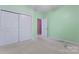 Light green bedroom featuring a closet, white trim and neutral carpet at 5022 Saybrook Dr, Harrisburg, NC 28075
