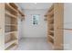 Well-organized walk-in closet with built-in shelving and ample storage space at 5022 Saybrook Dr, Harrisburg, NC 28075