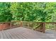 Wooden deck overlooking a lush green wooded area at 5022 Saybrook Dr, Harrisburg, NC 28075