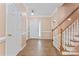 Inviting foyer featuring hardwood floors, a staircase, and a front door with glass sidelights at 5022 Saybrook Dr, Harrisburg, NC 28075