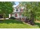 Charming two-story home featuring a covered front porch with classic white columns and well-manicured lawn at 5022 Saybrook Dr, Harrisburg, NC 28075