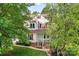 Charming two-story home featuring a covered front porch with classic white columns and well-manicured lawn at 5022 Saybrook Dr, Harrisburg, NC 28075