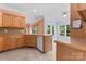 Bright kitchen featuring wooden cabinets, stainless steel appliances, and views to the backyard at 5022 Saybrook Dr, Harrisburg, NC 28075