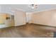 Open-concept living room with hardwood floors connecting to the kitchen at 5022 Saybrook Dr, Harrisburg, NC 28075