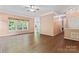 Open living room featuring hardwood floors and expansive windows with outdoor views at 5022 Saybrook Dr, Harrisburg, NC 28075