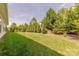 Well-manicured backyard with lush green grass and mature trees providing privacy and shade at 5128 Oakhaven Ln, Fort Mill, SC 29708