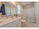 Bright bathroom featuring a vanity, toilet, and shower with glass enclosure at 5128 Oakhaven Ln, Fort Mill, SC 29708