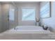 Bathroom soaking tub situated below a bright window at 5128 Oakhaven Ln, Fort Mill, SC 29708