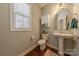 Charming powder room features a pedestal sink, toilet, and storage cabinet at 5128 Oakhaven Ln, Fort Mill, SC 29708