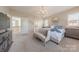 Bedroom with chandelier, accent furniture, neutral colors, and easy access to ensuite bathroom at 5128 Oakhaven Ln, Fort Mill, SC 29708