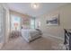 Cozy bedroom with natural light, soft carpet, and a view of the ensuite bathroom at 5128 Oakhaven Ln, Fort Mill, SC 29708